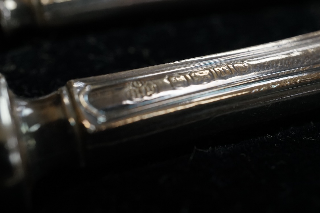 A cased set of twelve Edwardian silver apostle teaspoons with a pair of sugar tongs, Cooper Brothers & Sons, Sheffield, together with a cased Victorian silver bread knife and a cased set of six silver handled steel tea k